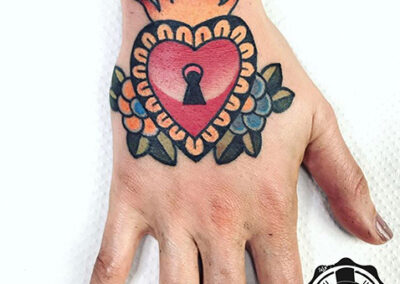 Tatuaje en la mano de un corazón estilo old school